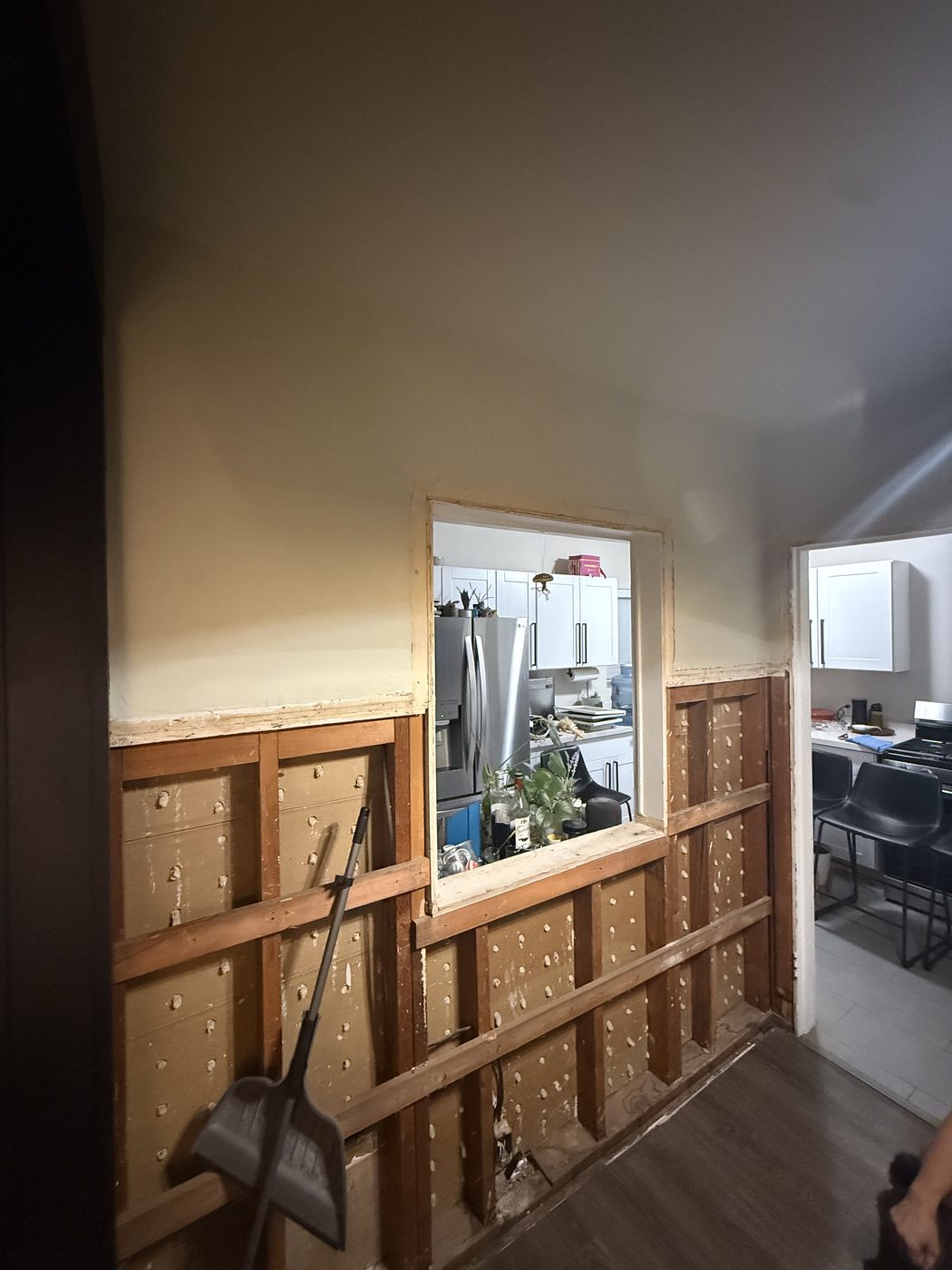 Interior wall stripped to the studs with the original pass through opening rough framed