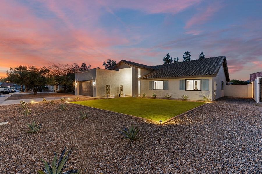 Renovated Mesa home exterior at dusk with landscape lighting