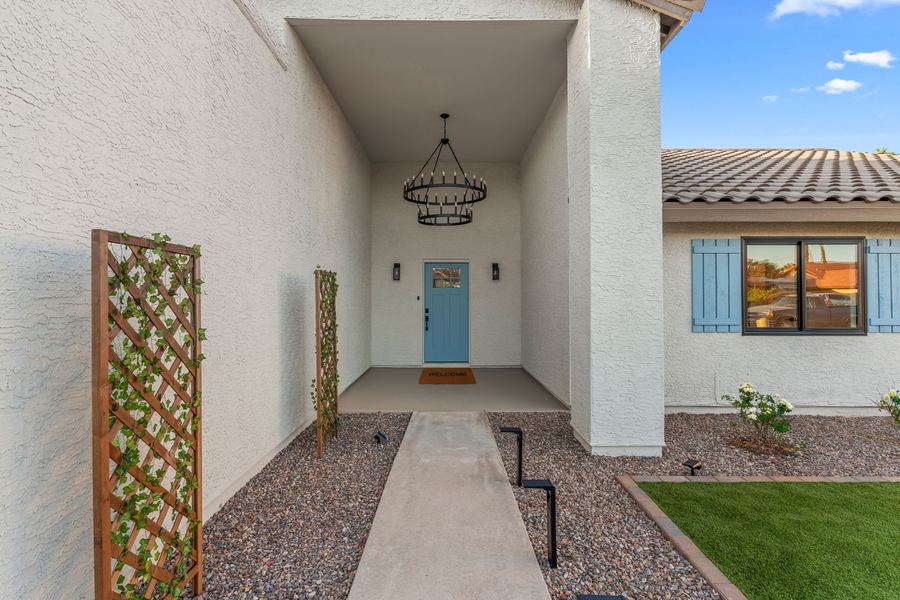 Front entry courtyard with a blue door and new landscaping