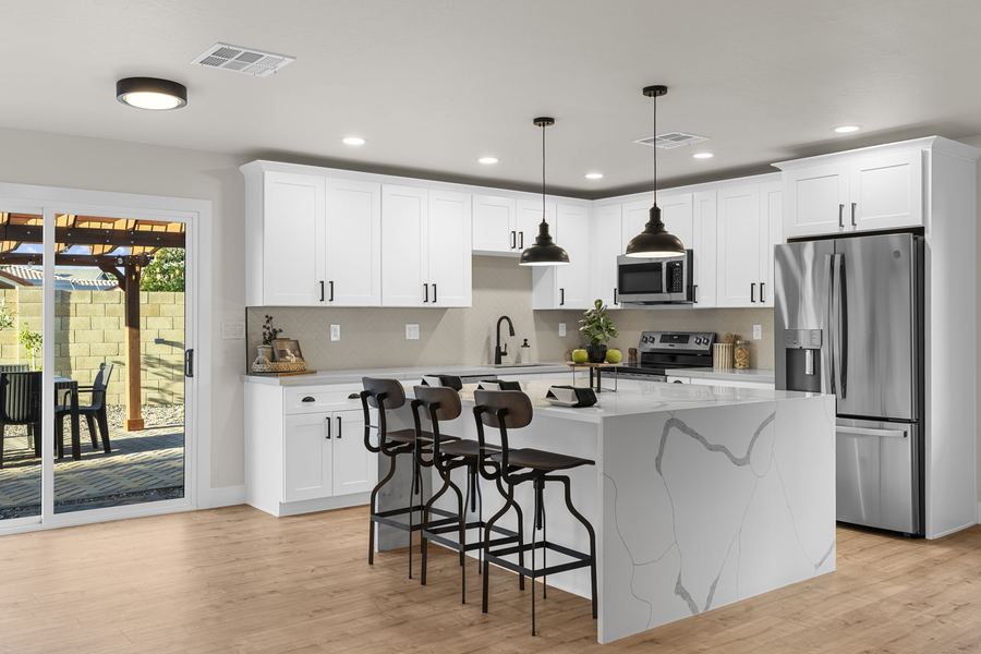 Quartz waterfall island with counter seating in the renovated Hackamore kitchen