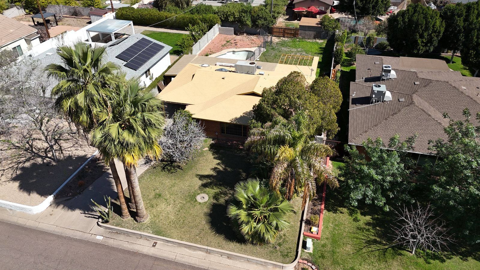 Street view of the original brick ranch home before the rebuild began