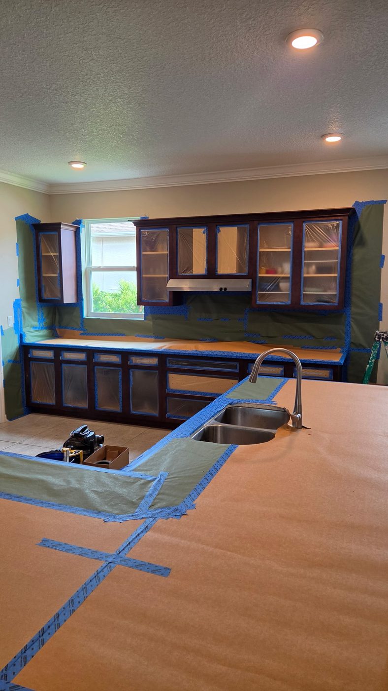 Window wall fully masked with paper and tape ahead of spraying